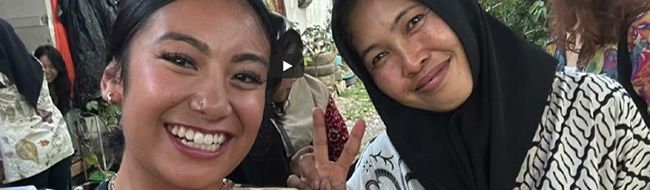 Internships: two women smile and one makes peace sign with two fingrs