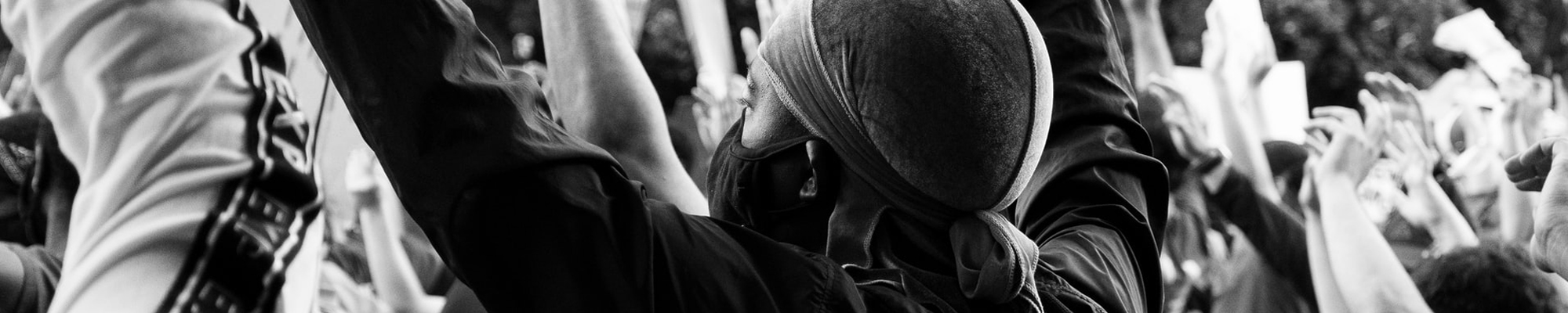 people at a protest wearing masks